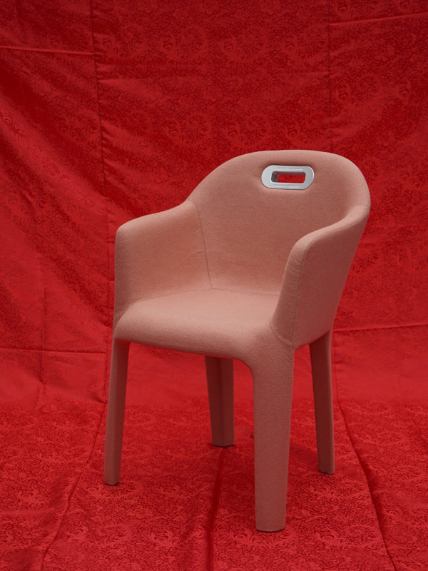 pink chair and red background